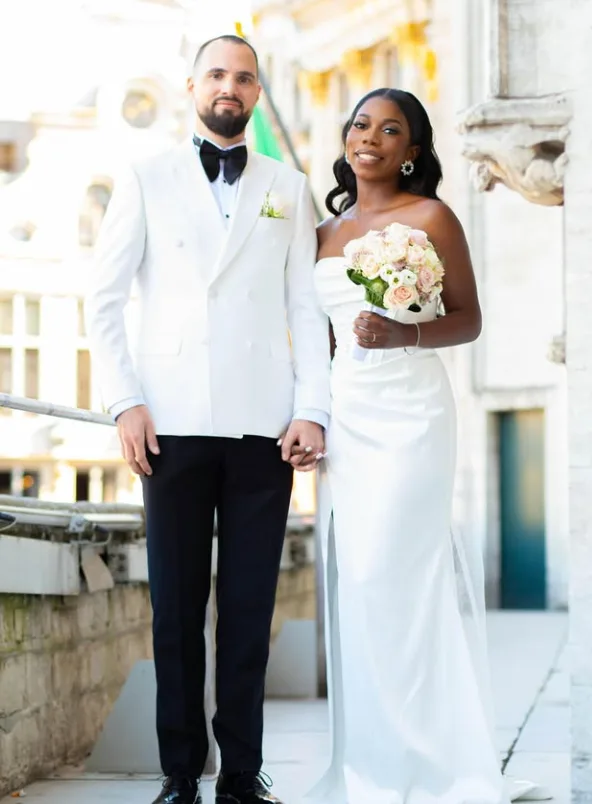 Groom in an ivory double-breasted dinner jacket beside his bride